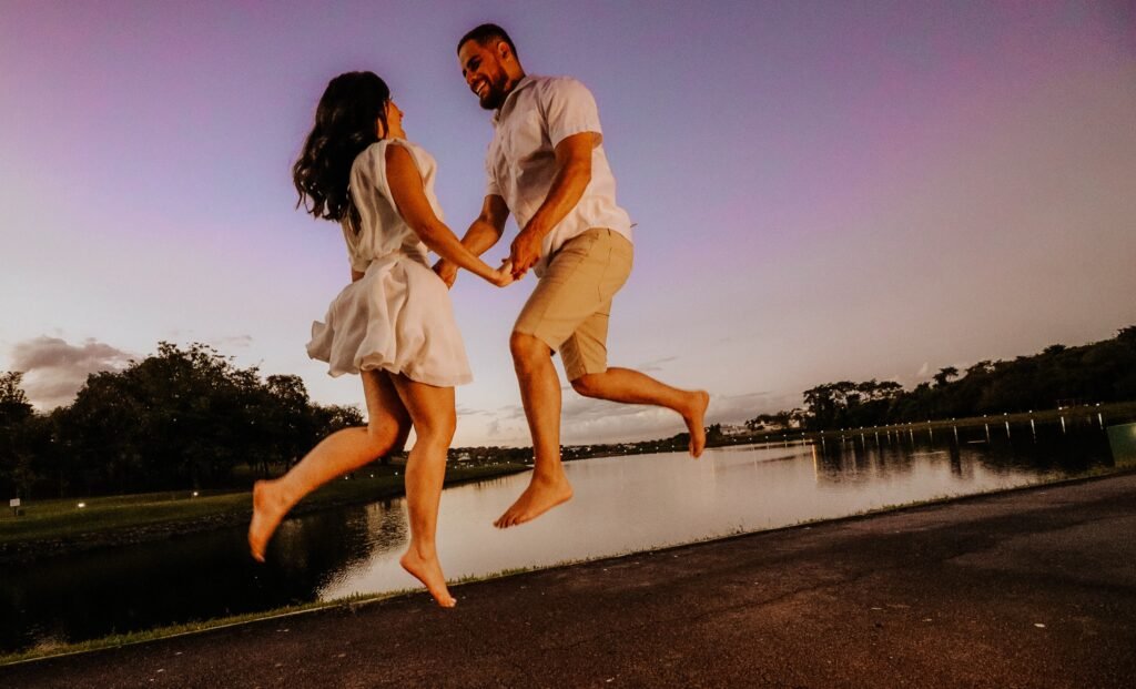 Casal pulando na frente de lago Goiania